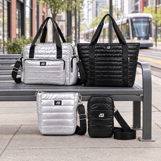 AJ quilted silver and black bags on a city streetcar stop bench